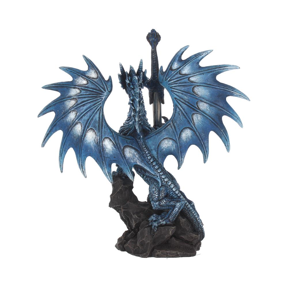 A blue dragon figurine sits perched atop a dark rocky base, its wings spread wide, a sword planted vertically between its wings.