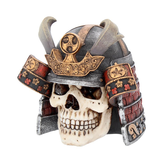 A skull adorned with a detailed, ornate samurai helmet, featuring decorative gold and red accents; it rests on a plain white background, emphasizing its intricate design.