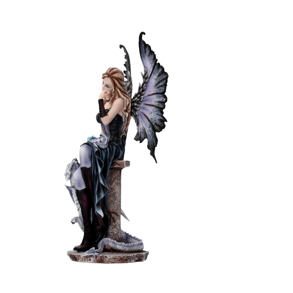 Fairy figurine with large, intricate wings, sits pensively on a stone pedestal. She wears a dark dress and knee-high boots, with a serpent coiled at the base. Background is plain white.