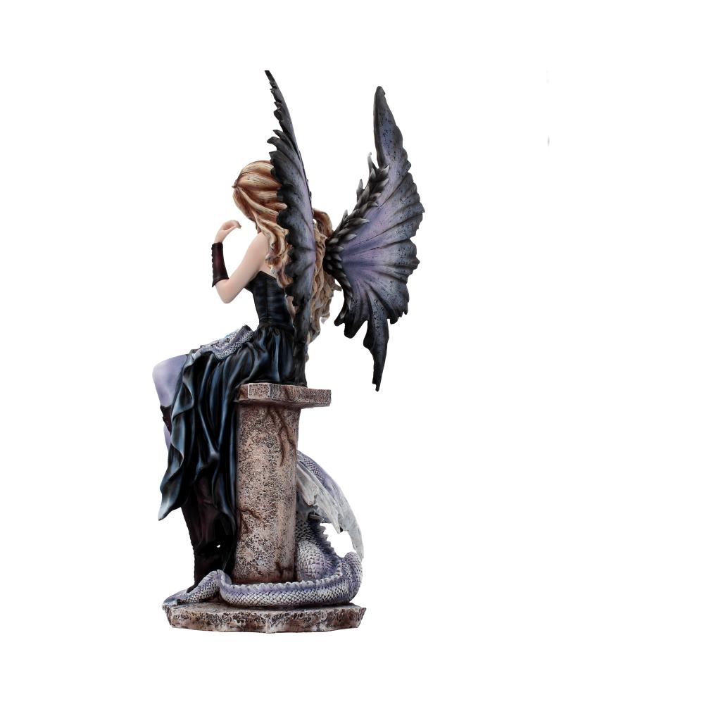 A fairy figurine sits on a stone pedestal, wings extended, in a contemplative pose. A curled dragon rests at the base, creating a whimsical, fantasy-themed setting.