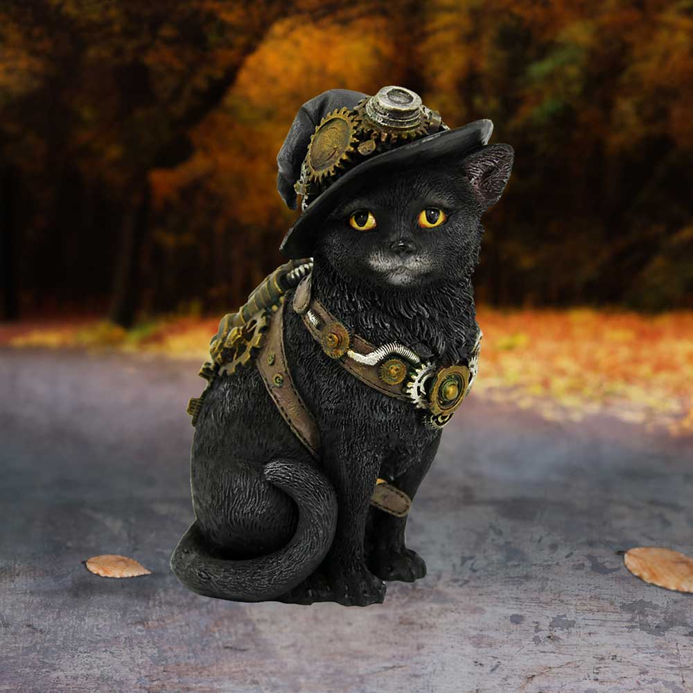 A black cat statue adorned with steampunk gears and a hat sits on a textured surface. The background features an autumnal, tree-lined path with orange and yellow foliage.