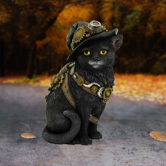 A black cat statue adorned with steampunk gears and a hat sits on a textured surface. The background features an autumnal, tree-lined path with orange and yellow foliage.