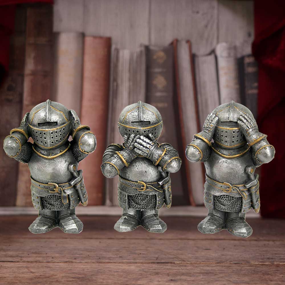 Three small knight figurines, each covering their ears, mouth, and eyes respectively, are arranged in a row. They are set against a backdrop of vintage books and a wooden surface.