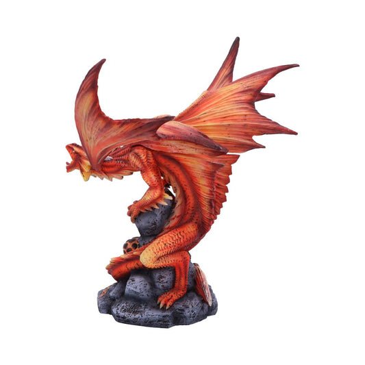 A red dragon figurine perched on black rocks, wings spread wide, appears ready to take flight. The detailed texture and vivid color create a dynamic, mythical scene.