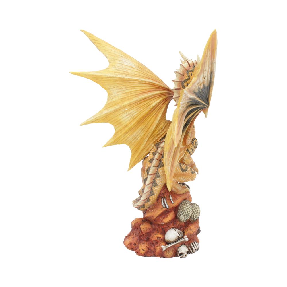 A detailed dragon figurine with expansive wings perched atop a rocky surface, surrounded by skulls and bones, conveying a mystical and ominous presence.