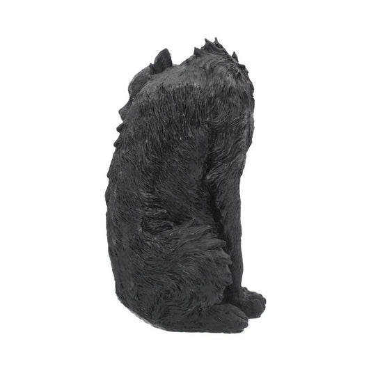 A black, textured sculpture of a sitting bear-like creature faces away, showcasing rugged fur details, with a neutral, white background highlighting the creature's silhouette.