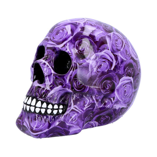 A skull is covered in a vibrant purple rose pattern, with hollow black eye sockets and white teeth, placed against a plain white background.