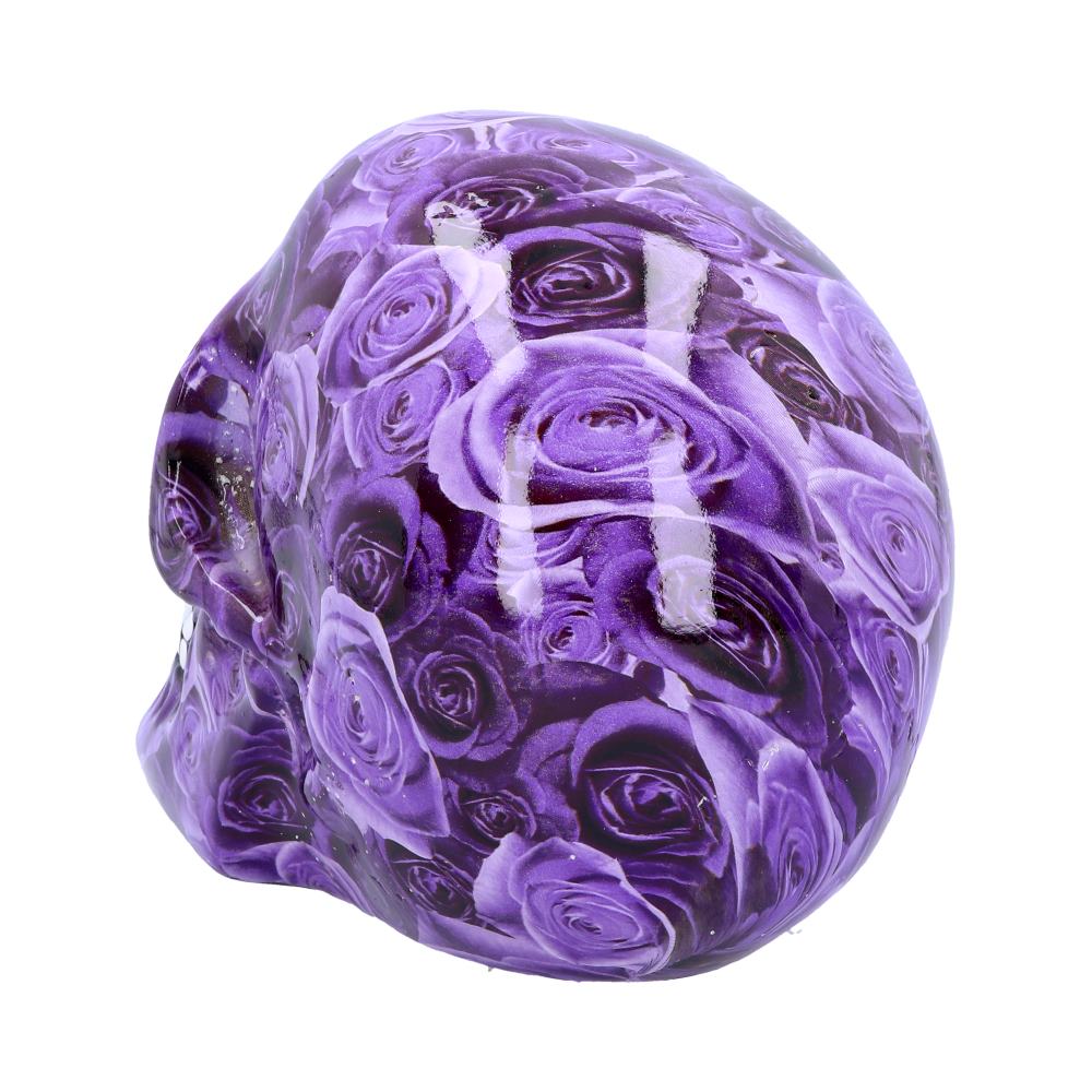 A skull-shaped object displays a vibrant pattern of purple roses, situated against a plain white background.