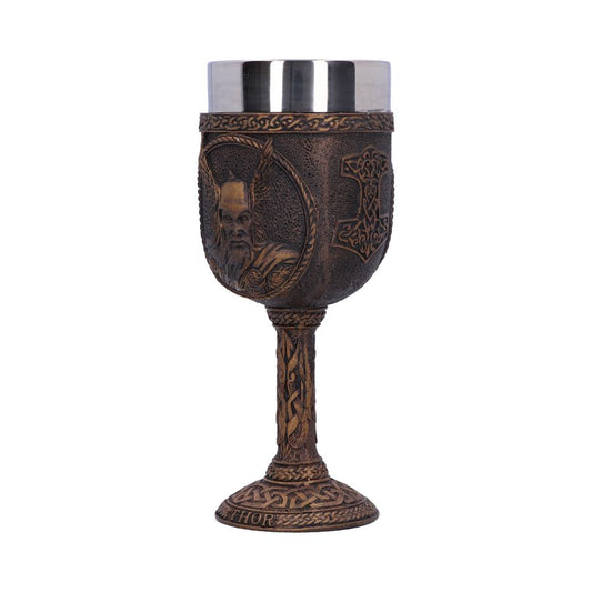 A bronzed goblet stands, featuring a stainless steel cup. The goblet is embossed with the face of a god and the "THOR" title at its base, all on a plain white backdrop.