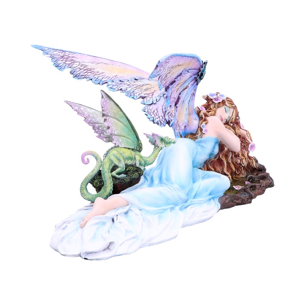 A fairy lies sleeping with a small green dragon perched on a rock near her. The fairy has large, iridescent wings and is in a pale blue gown.