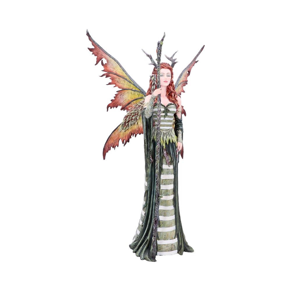 A fairy figurine stands tall, holding a staff. She has large, orange and yellow feathered wings, and is dressed in green and white in a plain, bright setting.