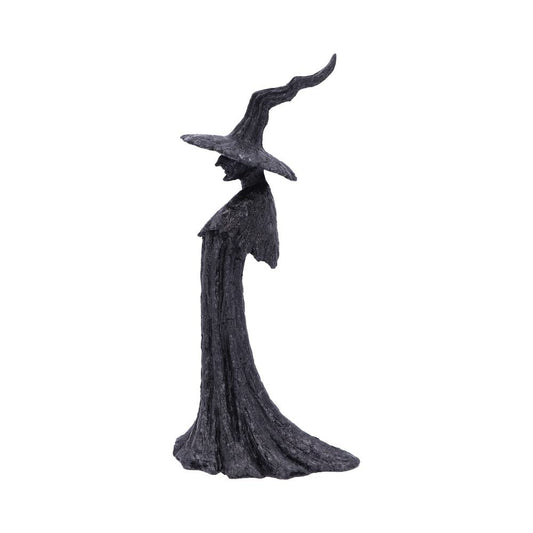 A textured black sculpture depicts a mysterious figure wearing a long, flowing robe and a twisted, pointed hat, evoking a mystical or witch-like presence against a plain white background.