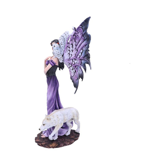 A fairy statuette in a purple dress poses while a white wolf stalks on a rocky base. The fairy also has large, intricate purple and white wings and a white owl on her shoulder.