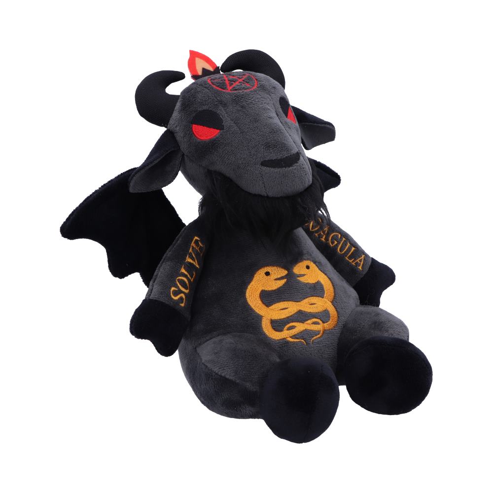 A plush toy goat with red eyes and black horns sits upright. It has wings and a beard, with pentagram and snake symbols, and the text "SOLVE" and "COAGULA."