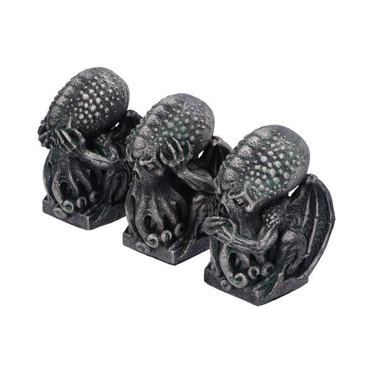 Three grayish-black Cthulhu-like figures sit side-by-side on small plinths. Each has its eyes, ears, or mouth covered by its hands, against a plain white backdrop.