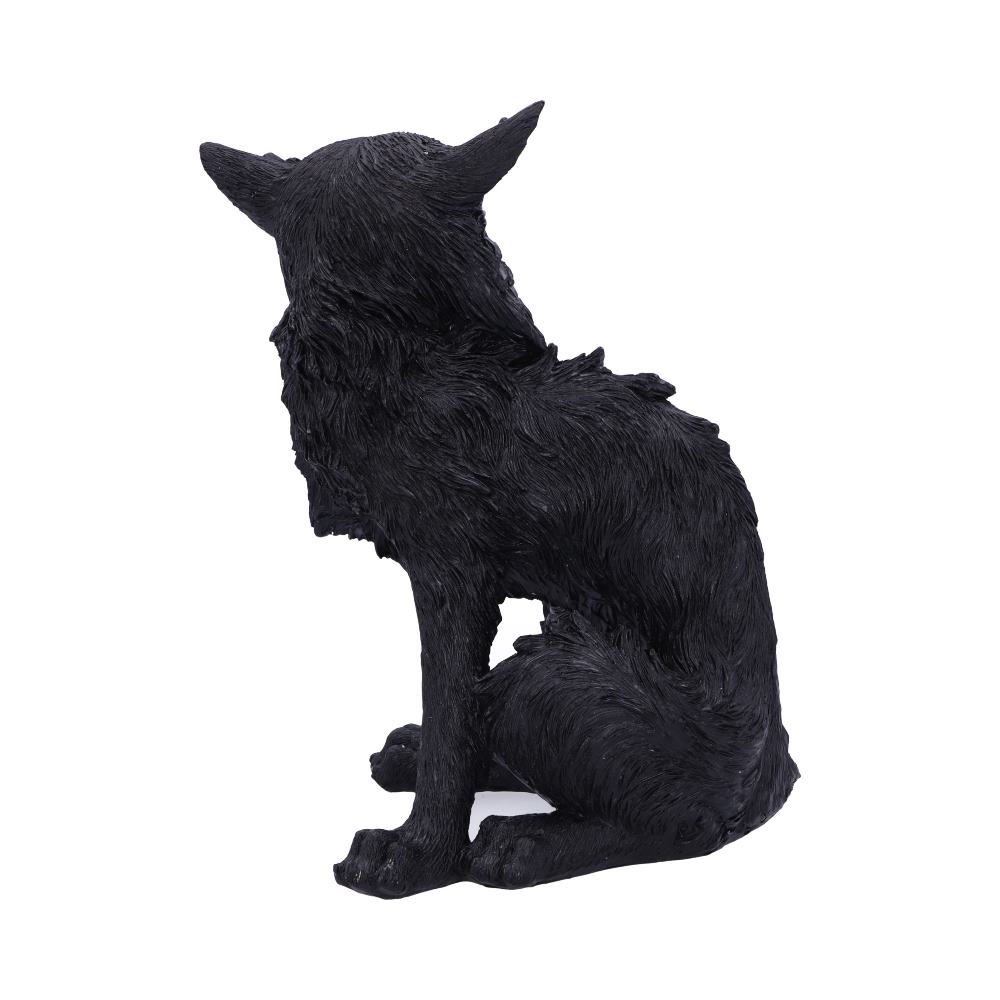 A black wolf sculpture is sitting in profile, displaying detailed fur texture, with its head turned slightly to the side. The background is plain white, emphasizing the figure.