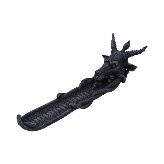 A black incense holder features a goat head with twisted horns, adorned with a textured snake body running along its length. It rests against a plain white background.