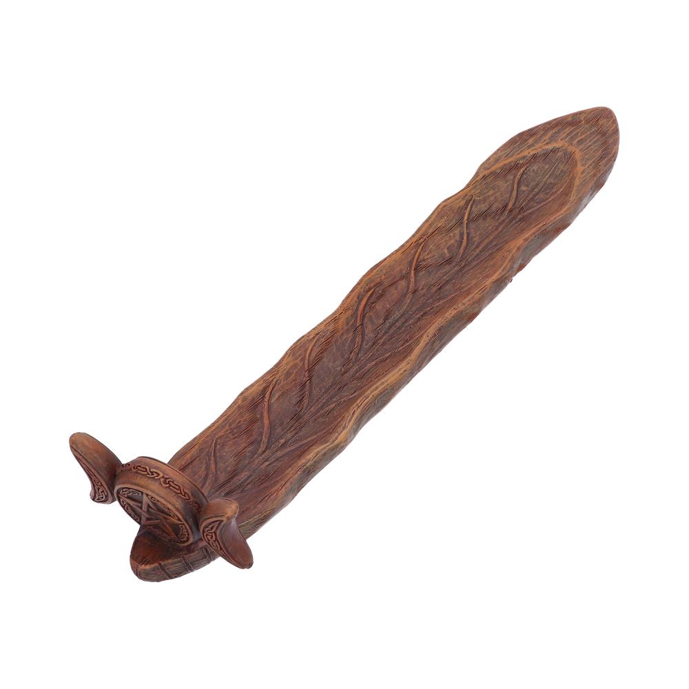 A carved wooden incense burner rests on a white background. The piece is long and narrow, with a design at one end.