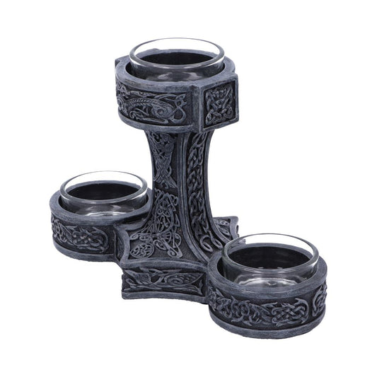 Intricately designed gray stone candle holder with Celtic patterns, featuring three circular holders. Two holders sit lower, while one is elevated, creating a tiered effect against a plain background.
