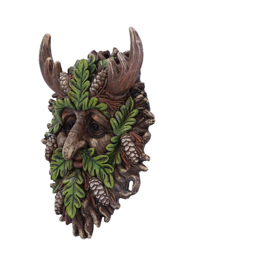 A detailed, wood-textured mask features a face formed by green leaves and brown pinecones, with deer antlers protruding, set against a plain white background.