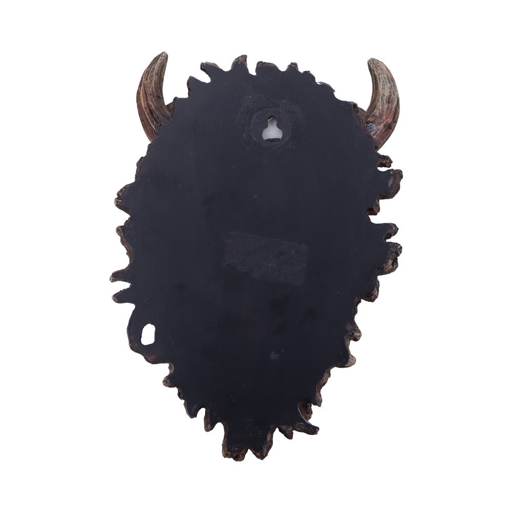 A wall-mounted object with a dark, irregular shape features protruding, curved horn-like elements. It appears textured and sturdy, designed for decorative purposes in a neutral, well-lit space.