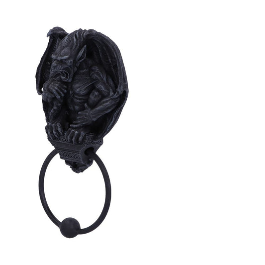 A sculpted gargoyle door knocker hangs. It is mostly black with an ornamental base holding a black ring knocker with a round ball at the bottom. It's on a white background.