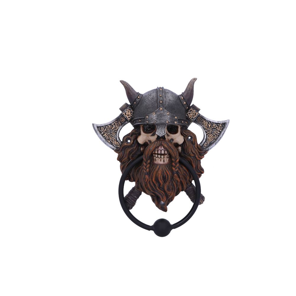 A Viking skull door knocker, wearing a helmet and wielding axes, is mounted on a door.