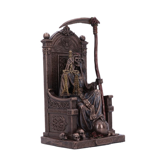 The Grim Reaper sits on an ornate throne, holding scales of justice; its scythe rests nearby. "SANTA MUERTE" is etched on the base, surrounded by skulls.