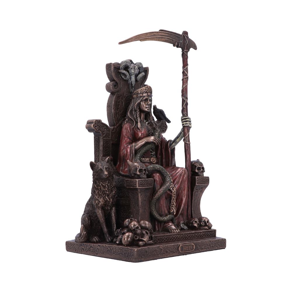 A detailed statue depicts a figure seated on a throne, holding a scythe, with a raven perched on their arm, surrounded by wolves and skulls. The base reads "HEL."