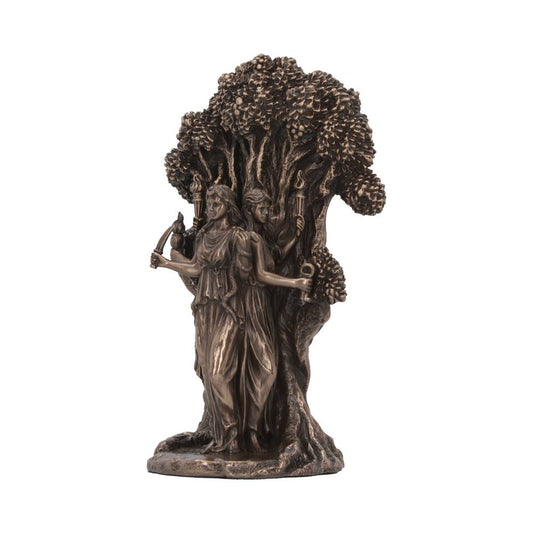 A bronze statue depicting three female figures with torches standing back-to-back, emerging from a tree with dense foliage. The figures wear flowing gowns, creating an elegant and mythical appearance.