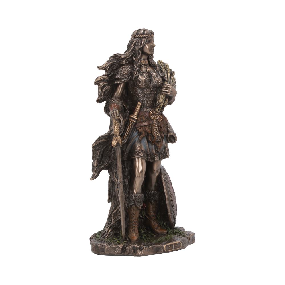Statue of a figure wearing armor, holding wheat and a sword, standing on a base labeled "SIF." The detailed texture suggests a warrior theme, with flowing hair and cape.