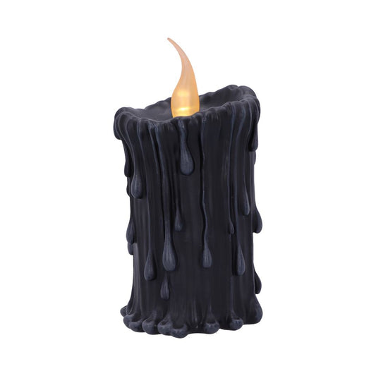 A black candle displays a glowing flame on top, with melted wax drips cascading down its sides, set against a plain white background.