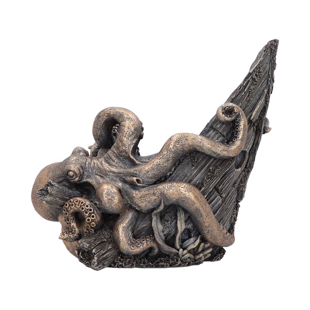 A bronze-colored octopus sculpture entwines its tentacles around a weathered wood-like surface, resembling a shipwreck's mast, set against a plain white background.