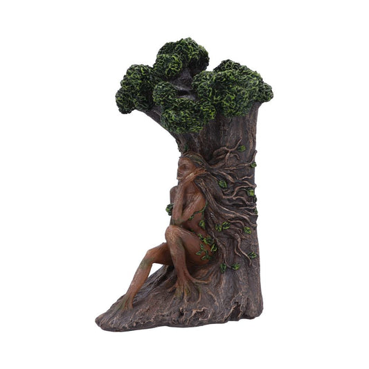 A tree-woman sculpture with leafy hair and limbs forming roots, sits integrated into a trunk with green foliage, suggesting a whimsical forest scene.