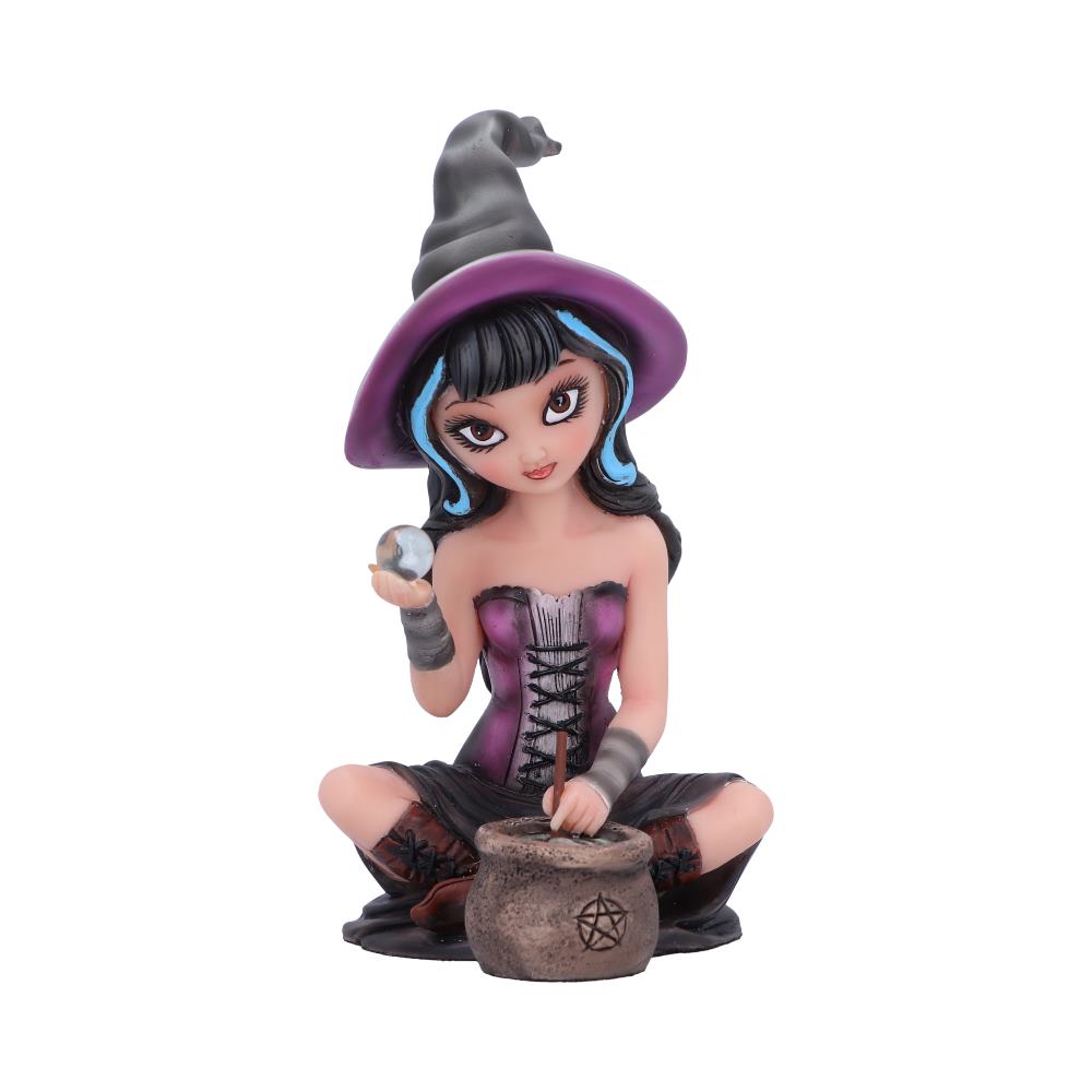 A figurine of a witch holds a crystal ball, sitting cross-legged, wearing a purple corset and hat. In front is a small cauldron with a pentagram, against a plain white background.