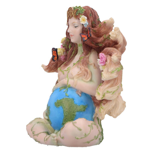 A figurine of a pregnant woman, with earth as her belly, adorned with flowers and butterflies in her hair; sitting gracefully, representing nature and motherhood in a serene environment.