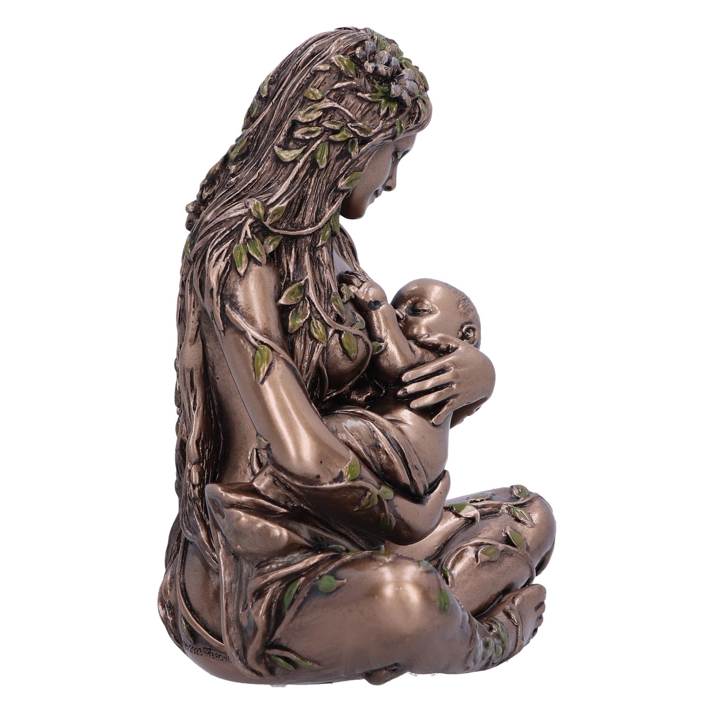 A bronze-colored statue of a seated woman, adorned with leaves, is breastfeeding a baby. The woman looks down lovingly at the child in a white space. Text on the statue's base reads: "©2023 Veronese."