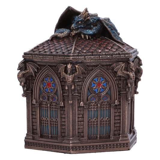 A metallic box features a detailed dragon resting atop a Gothic-style architecture with stained glass windows, intricate carvings, and small gargoyle-like statues, creating a medieval fantasy atmosphere.