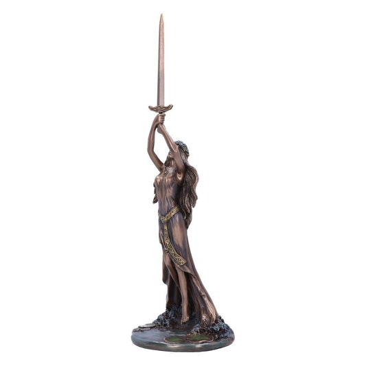 Bronze-colored statue of a woman holding a sword aloft with both hands, standing on a decorative circular base adorned with water-like details, symbolizing an iconic, mystical scene.