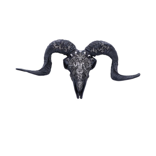 A decorative ram skull features intricate carvings and metallic detailing on its surface. The large, curved horns add a dramatic element, set against a plain white background.