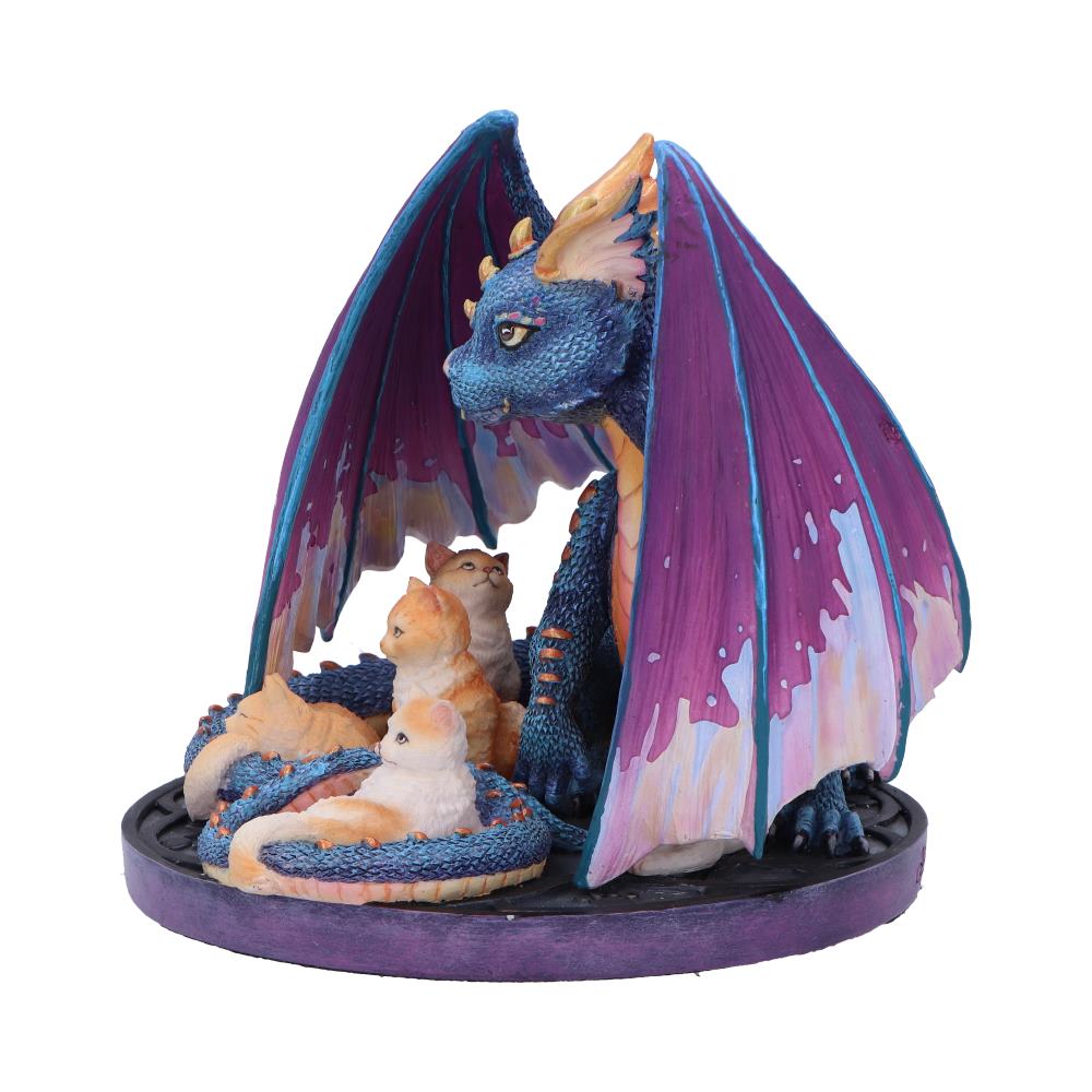 A dragon statuette protects four kittens. The dragon is blue with purple wings, the kittens are orange and white, and the whole arrangement is set on a round, ridged base.