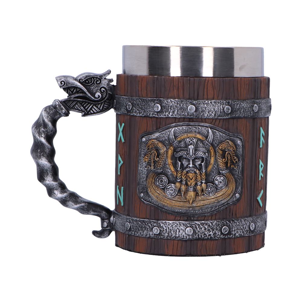 A Viking-themed mug features a silver dragon head handle and silver rims around a wooden body. Embossed with an Odin emblem, it also features etched runes "X, P, N, R, K" around its body.