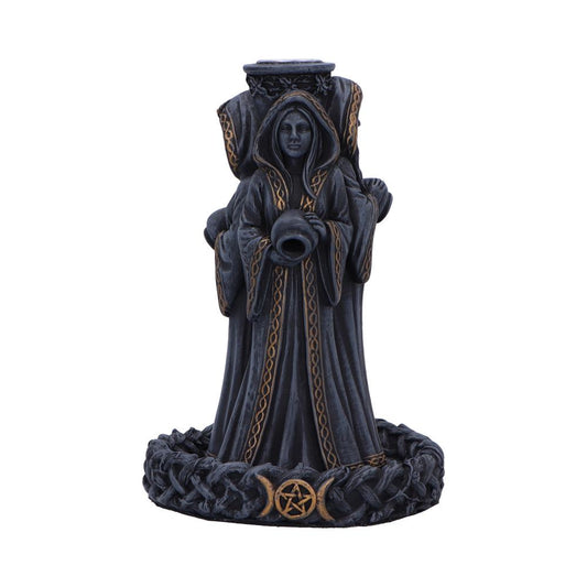 A dark, robed female figure, holding a vessel, stands atop a circular base with Celtic knotwork and symbols; the statue is an incense burner.