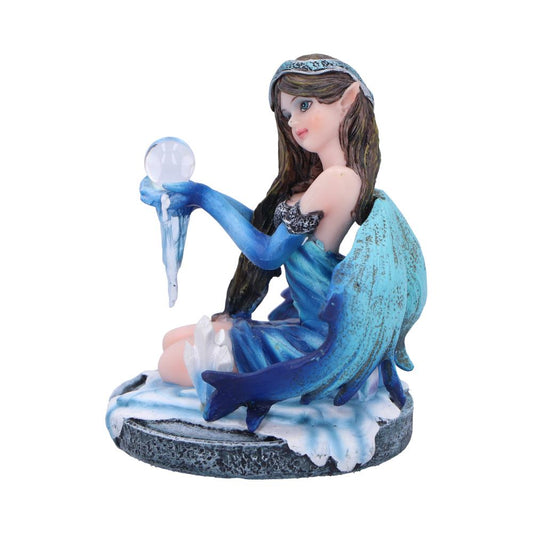 A blue-winged fairy figurine holds a crystal ball, perched on an icy base.