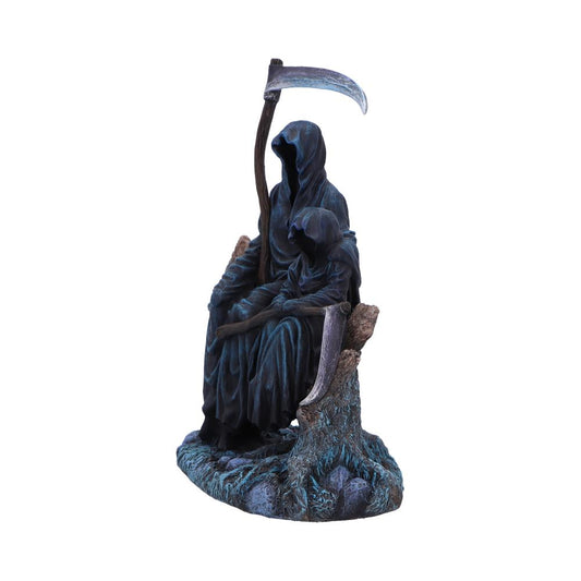 A dark-blue Grim Reaper figurine sits, holding a scythe, with a smaller hooded figure resting on its lap, on a textured base resembling a tree stump.