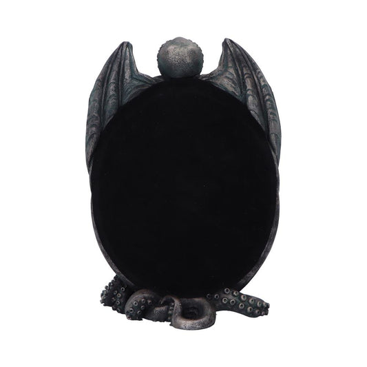Oval black display framed by sculpted bat wings with a textured orb at the top and tentacles curling around its base, photographed against a white background.