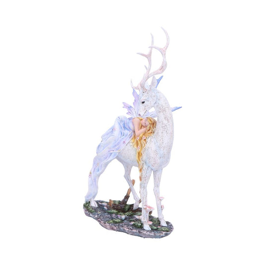 A white stag with antlers stands in a meadow. A fairy with purple wings and flowing gown rests peacefully on its back.