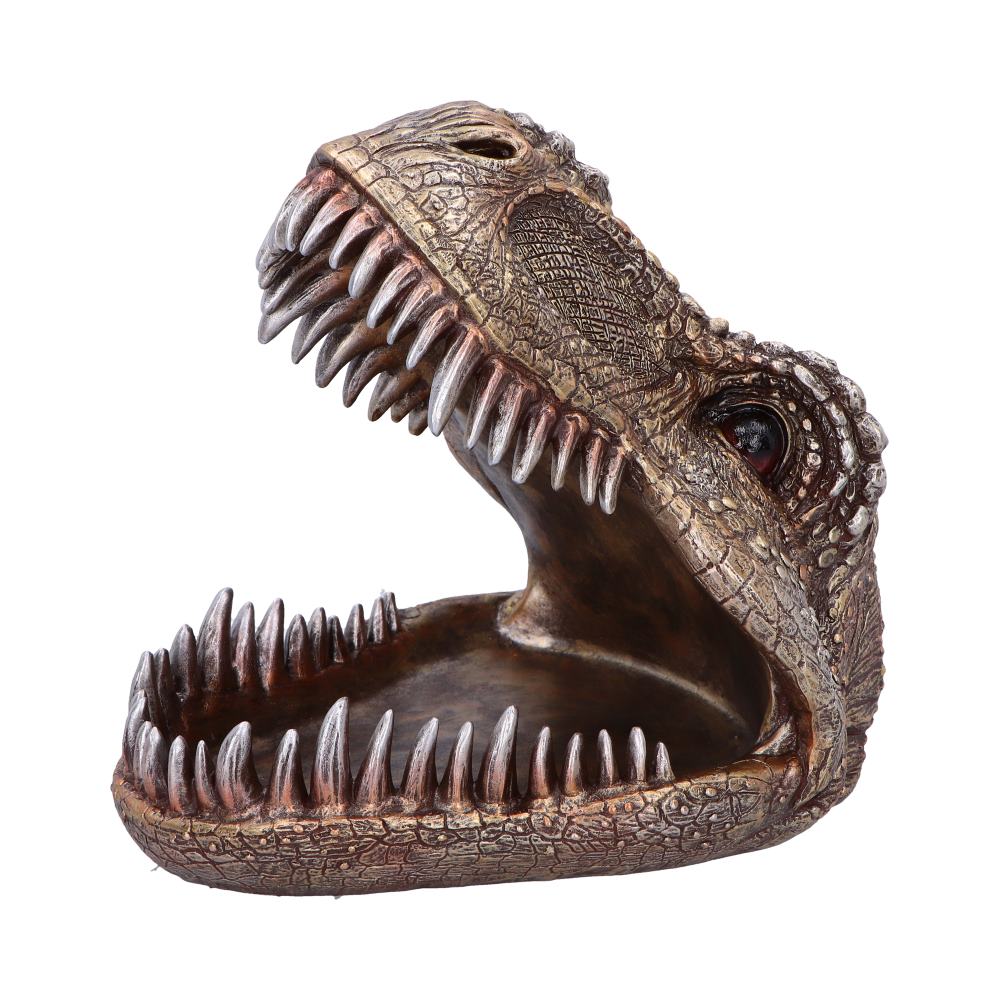 A sculpted dinosaur head with an open mouth, revealing sharp teeth; textured surface suggesting aged, bronze-like skin; isolated on a plain, white background.