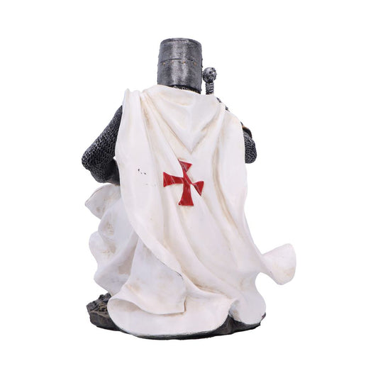 Medieval knight figurine stands facing away, wearing a white flowing cloak bearing a red cross, chainmail sleeves and a bucket helmet against a plain white background.