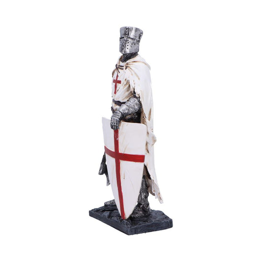 Medieval knight figurine stands on a rocky base holding a white shield bearing a red cross, wearing chainmail, helmet and tattered white cloak against a white background.